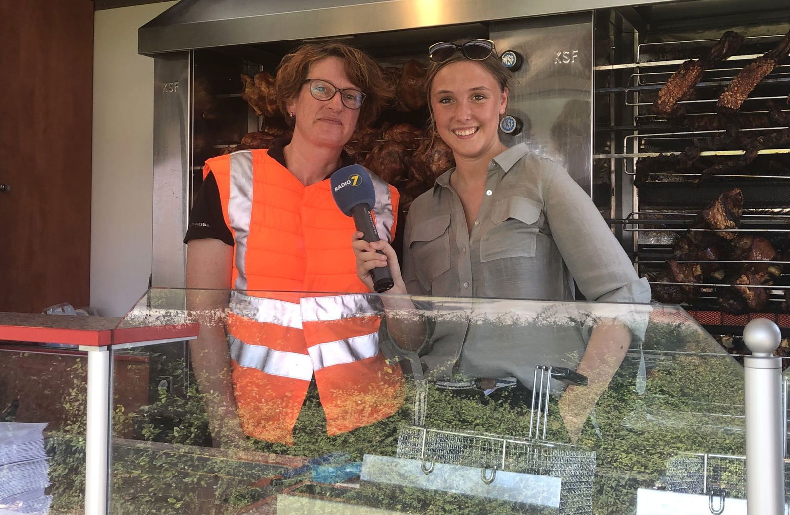 Steffi vom Hend’l und Hax’n Grill in Neu Ulm in Kühlweste mit Radio 7 Reporterin Anna Dworak